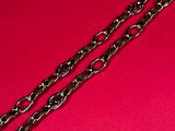 two silver chains on a red surface with a red background