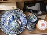 a box full of blue and white plates and bowls