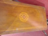 a small wooden table with a flower design on it