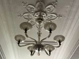 a silver chandelier hanging from the ceiling in a room