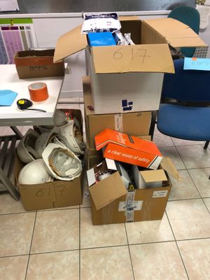 a pile of boxes sitting on the floor next to a desk