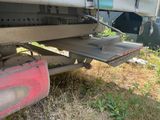 underside view of a semi truck with a flat bed and a flat bed
