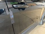 a close up of a car door handle with a sticker on it
