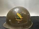 an old army helmet with a coat of arms on it