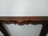 a wooden table with a carved top on it