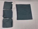 four pieces of blue cloth are laid out on a white surface