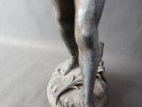 a statue of a boy with a bird on his shoulder