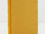 a yellow book sitting on top of a white table