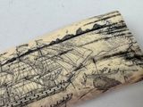 an elephant ' s tusk with a drawing of a ship on it