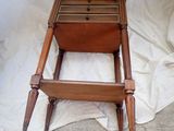 a wooden bed with a drawer on top of it