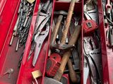 many different tools in a red box on the floor