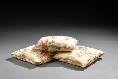 three pillows sitting on top of each other on a table