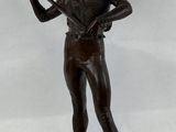 bronze statue of a man holding a knife and a knife in his hand