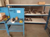 a blue workbench with tools on it in a room