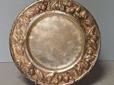 a silver plate on a stand on a table