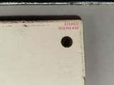 a close up of a metal object with a red label on it