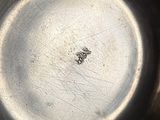 a close up of a metal bowl with a small insect in it