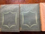two books sitting on a table with a wooden table top