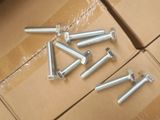 many screws and nuts on a cardboard box