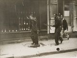 a black and white photo of a group of men on the street
