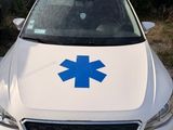 the front of a white car with a blue star of life sticker on it