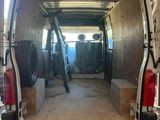 a van that is parked in a garage with the door open