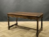 an old wooden table sitting on top of a hard wood floor