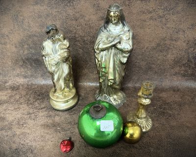 two statues of jesus and a green vase on the floor