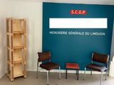 une photo d'une salle d'attente avec des chaises et un panneau