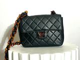 a small black purse sitting on top of a radiator