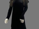 an image of a mannequin wearing a black dress with fringes
