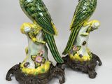 pair of green and yellow parrot figurines sitting on top of a table