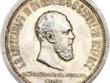 Gros plan sur une pièce de monnaie portant le visage d'un homme