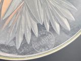 a close up of a glass vase with a flower inside of it