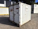 a white container sitting in the middle of a parking lot