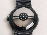 a close up of a watch on a white surface