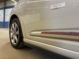 a white car parked in a garage with a sticker on the side of it