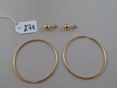 two pairs of gold hoop earrings and a gold bead earring