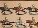 six figurines of men riding on horses in a box