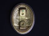 a close up of a coin on a black surface