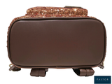 a brown suitcase with sequins on it on a white background