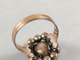 an image of a gold ring with a stone in the center