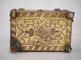 a small metal box that has a design on it