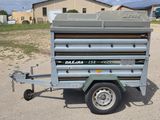 a trailer with a trailer attached to it in the dirt