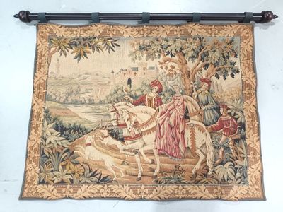 a tapestry hanging on the wall with a picture of a man on a horse