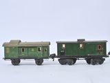 two toy trains sitting side by side on a white surface