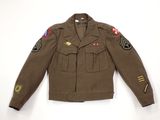 an army uniform jacket with patches on the sleeves and shoulder