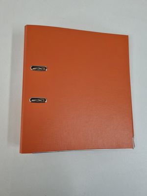 an orange binder with two metal clips on top of it