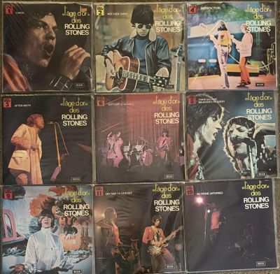 a lot of rolling stones album covers on the wall