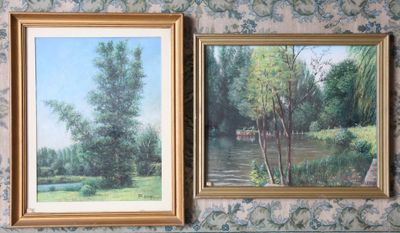 two paintings of trees are hanging on a wall in a room